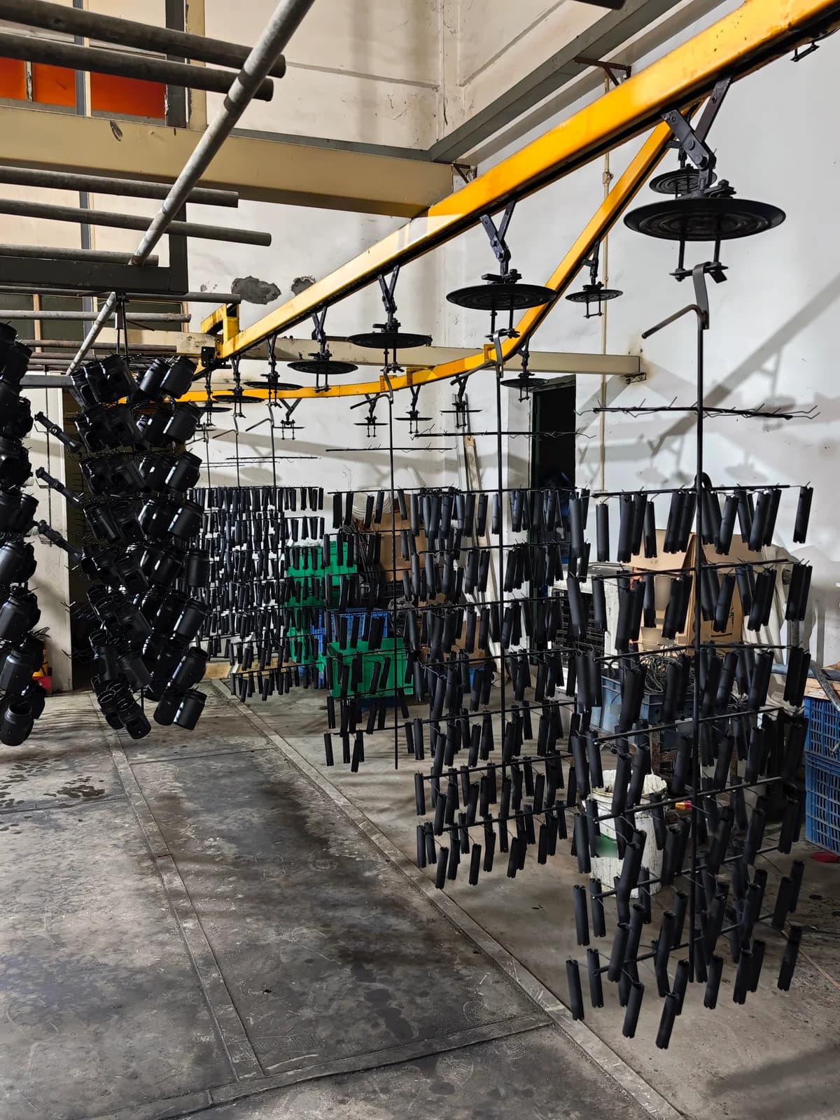 Components suspended beneath an overhead rack processing line.